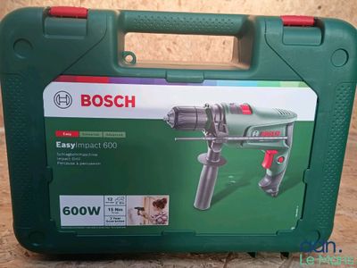 a green box with a tool in it sitting on a table