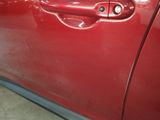 a close up of a red car door handle