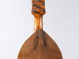 an image of a wooden instrument hanging from a string