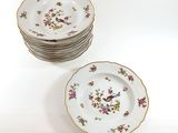 a stack of plates with flowers on them on a table