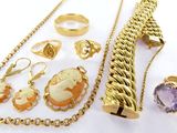 a lot of jewelry that is laying out on the table
