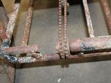 a rusted metal bed frame that has been placed on the floor