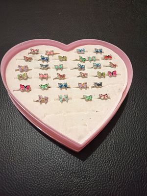 a pink heart shaped box with a bunch of little animals on it
