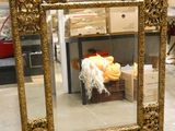 a mirror that is sitting on the floor in a store