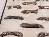a lot of silver spoons that are on a table
