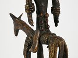 bronze statue of a man on a horse with a horse in the foreground