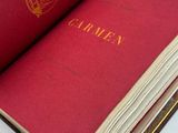 a red book that is open on a white table