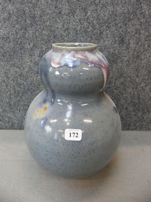 a blue vase sitting on a table with a tag on it