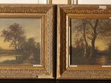 two paintings of trees and a river are on display in front of a wall