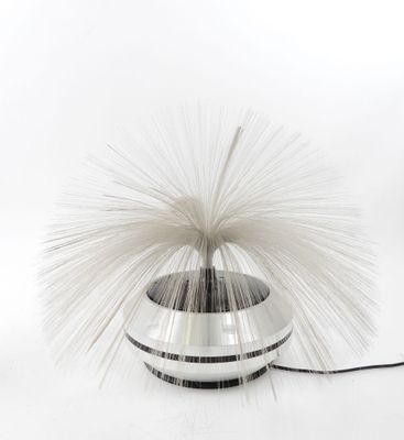 a white and black vase with a white and black ball on it