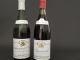 two bottles of wine sitting next to each other on a table