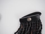 a black purse with beads hanging from it ' s side