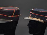 pair of hats on mannequin heads on a black background