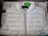 a white vest with a green tag on it in a box