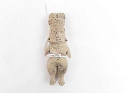 a small statue of a bear holding a piece of paper