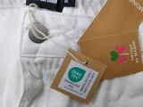 a label on the back of a pair of white pants