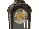 a clock with a man on top of it on a white background