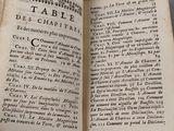 an open book with writing on it sitting on top of a table