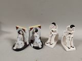three figurines of a woman and a man on skis