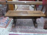 a wooden bench sitting on a rug in a room