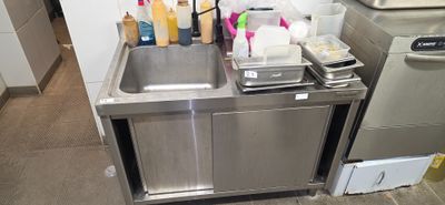 a sink and a dishwasher in a small kitchen