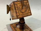 an old book on a wooden stand with a knife stuck in it