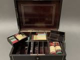 an old black box with a set of poker cards and other items in it