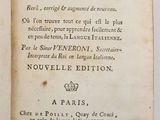 an open book on a white surface with a black and white title