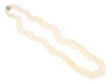 a three strand pearl necklace with a diamond clasp