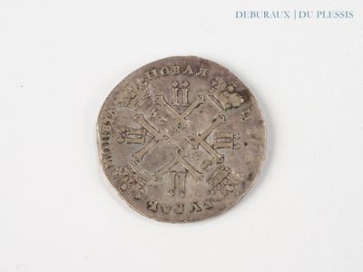an old coin with a cross on it on a white surface