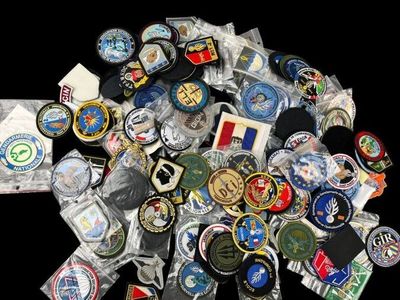 a pile of badges and badges on a black background