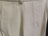 a close up of a pair of white pants on a hanger