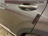 a close up of a car door handle with a sticker on it