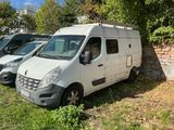 three vans parked next to each other in the grass