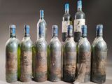 several bottles of wine are lined up in a row on a table