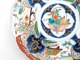 a plate with a basket of flowers on it