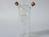 a glass bottle with a bunch of grapes inside of it