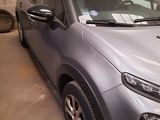 a silver car that is parked in a garage