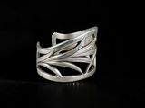a close up of a silver ring on a black surface
