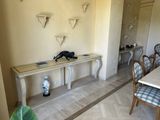 a table and chairs in a room with a mirror on the wall