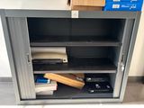 a metal cabinet that has many items in it
