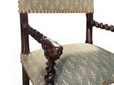 an old chair with a green upholstered seat