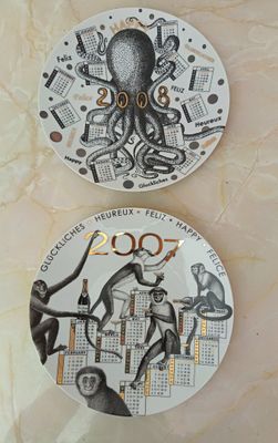 two plates with different designs on them on a table