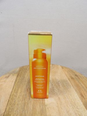 the box is on the table next to the bottle of sunscreen