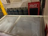 a coke machine in the corner of a room