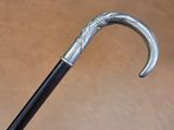 a close up of a walking stick with a metal handle