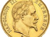 a close up of a gold coin with a man ' s face on it