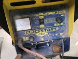 a machine that is sitting on the ground next to a pile of tools