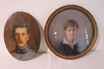 two framed portraits of a man and a woman in military clothing