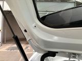 a white car with the door open and a window open